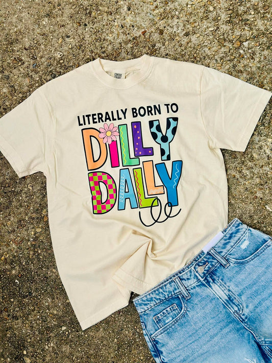 Beige t-shirt with colorful text 'Dilly Dally' on a textured surface