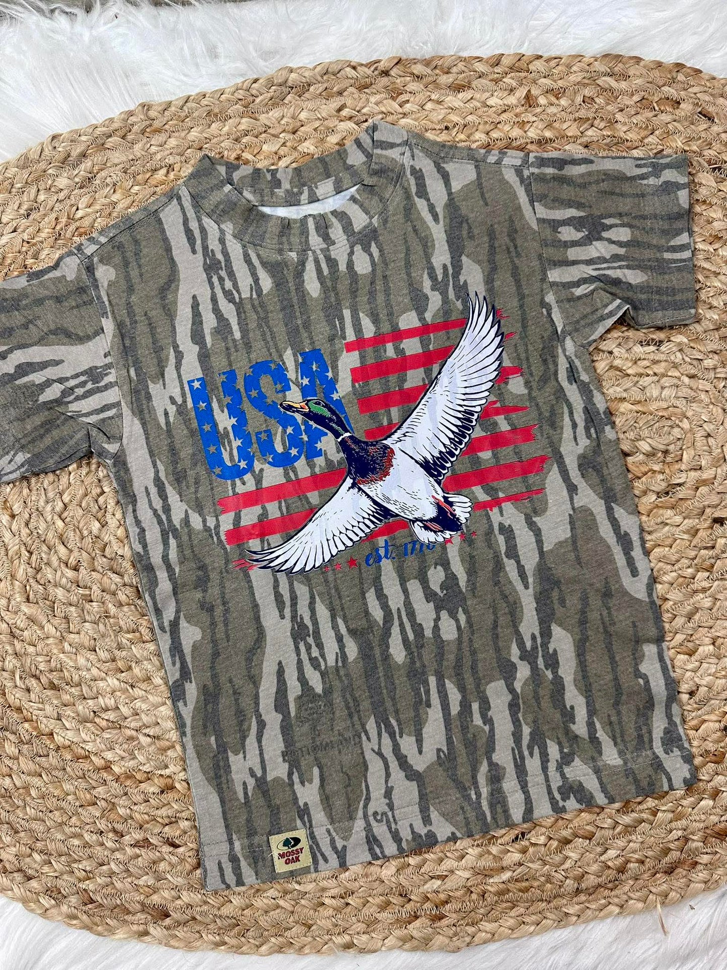 Camouflage t-shirt with USA and mallard duck like  eagle design on a woven mat