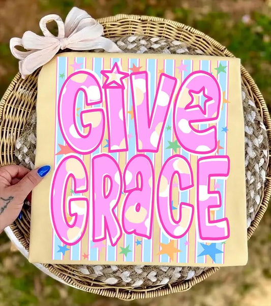 Decorative sign with 'Give Grace' text on a striped background, held over a woven basket.